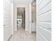 Hallway leading to powder room, living room and patio at 7920 Draw St, Reunion, FL 34747