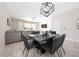 Open-concept living area with a sleek dining table, modern light fixture, and comfortable seating at 7920 Draw St, Reunion, FL 34747