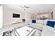 Bright living space featuring a comfortable sofa, stylish decor, and a view into the kitchen and dining area at 7920 Draw St, Reunion, FL 34747