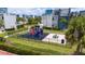 Community playground with slides, picnic table, and nearby townhome residences at 7920 Draw St, Reunion, FL 34747