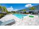 Sparkling community pool is surrounded by pavers, lounge chairs, and mature landscaping at 7920 Draw St, Reunion, FL 34747