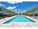 The inviting community pool offers a refreshing escape with palm trees, lounge chairs, and a nearby cabana at 7920 Draw St, Reunion, FL 34747