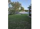 Well-maintained backyard with a hammock, firepit and white fence at 7971 Brofield Ave, Windermere, FL 34786
