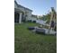Expansive backyard featuring a fire pit, outdoor seating, and hammock at 7971 Brofield Ave, Windermere, FL 34786