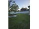 Wide backyard with a fire pit and white fence at 7971 Brofield Ave, Windermere, FL 34786