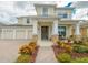 Charming two-story home featuring a welcoming front porch, three-car garage, and well-maintained landscaping at 7971 Brofield Ave, Windermere, FL 34786