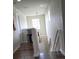Hallway features wood floors, with a hanging light fixture and views to downstairs at 7971 Brofield Ave, Windermere, FL 34786