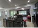 Kitchen featuring an island, stainless steel appliances, and an open view to the dining area and living room at 7971 Brofield Ave, Windermere, FL 34786