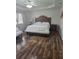This room features wood floors and a large bed with a decorative headboard at 7971 Brofield Ave, Windermere, FL 34786