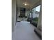 Enclosed porch with sleek flooring, a TV, and outdoor access at 7971 Brofield Ave, Windermere, FL 34786