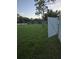 Large lawn with white fence and mature shade trees at 7971 Brofield Ave, Windermere, FL 34786