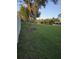 Wide green yard with mature trees and white fence at 7971 Brofield Ave, Windermere, FL 34786