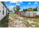 Spacious backyard featuring a pool with a deck, a play area, and a white privacy fence at 8 Orchid Ct, Kissimmee, FL 34759