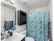 Bathroom featuring a vanity with countertop, toilet, and shower with decorative mermaid curtain at 8 Orchid Ct, Kissimmee, FL 34759