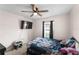 Comfortable bedroom with a ceiling fan, and a window providing natural light at 8 Orchid Ct, Kissimmee, FL 34759