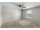 Clean bedroom with natural light, neutral carpeting, and a ceiling fan at 8 Orchid Ct, Kissimmee, FL 34759