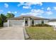 Charming single-Gathering home with a two-car garage, well-maintained lawn, and attractive landscaping at 8 Orchid Ct, Kissimmee, FL 34759