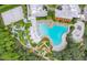 Aerial view shows a community pool, mini golf, and various resort amenities in a lush, tropical setting at 816 Longboat Dr, Davenport, FL 33896