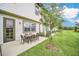 A patio table with seating overlooks a spacious green yard, perfect for outdoor enjoyment and entertaining at 816 Longboat Dr, Davenport, FL 33896