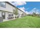 A spacious, lush backyard is shown, perfect for and pets to play at 816 Longboat Dr, Davenport, FL 33896