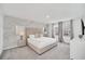 Bright bedroom features a king bed, neutral decor, carpet, and windows with natural light at 816 Longboat Dr, Davenport, FL 33896