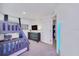 A themed bedroom with a bunk bed, wall-mounted TV and unique decor at 816 Longboat Dr, Davenport, FL 33896