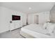Bright bedroom features white furniture, neutral decor, carpet, and access to other rooms at 816 Longboat Dr, Davenport, FL 33896