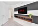 Modern bedroom featuring a TV, unique wall design, and floating shelves at 816 Longboat Dr, Davenport, FL 33896