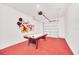 A garage features red floors, an air hockey table, and Mickey Mouse wall decor at 816 Longboat Dr, Davenport, FL 33896