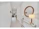 Bright hallway featuring tile floors, a console table with decor, and views into the rest of the home at 816 Longboat Dr, Davenport, FL 33896