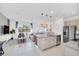 Open-concept kitchen and living space features stainless steel appliances, granite countertops, and modern furnishings at 816 Longboat Dr, Davenport, FL 33896