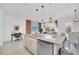 Bright open-concept kitchen flows to living space with stainless appliances and granite countertops, with stylish decor at 816 Longboat Dr, Davenport, FL 33896