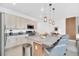 Island kitchen with stainless appliances, granite countertops, overhead lighting and bar stools at 816 Longboat Dr, Davenport, FL 33896