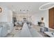 Open-concept living room featuring modern lighting, neutral decor, kitchen island with bar seating and dining area at 816 Longboat Dr, Davenport, FL 33896
