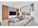 Modern living room featuring neutral decor, sleek furniture, large window, and plenty of natural light at 816 Longboat Dr, Davenport, FL 33896