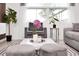 Bright and modern living room featuring sleek furniture, a coffee table, and large sunlit windows at 816 Longboat Dr, Davenport, FL 33896