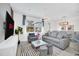 Bright and airy living room featuring modern lighting, sleek furniture, and a dining area at 816 Longboat Dr, Davenport, FL 33896