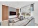 Comfortable living room featuring modern lighting, a wall-mounted TV, sleek furniture and a striped rug at 816 Longboat Dr, Davenport, FL 33896