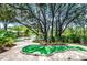 Fun mini golf course winding through lush tropical landscaping and mature trees at 816 Longboat Dr, Davenport, FL 33896