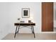 A cozy home office nook features a modern desk with decor, wood accent wall, and neutral flooring at 816 Longboat Dr, Davenport, FL 33896