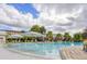 Large swimming pool featuring lounge chairs, umbrellas and beautiful landscaping at 816 Longboat Dr, Davenport, FL 33896