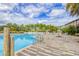 Sparkling pool and splash pad with striped brick decking and lounge chairs at 816 Longboat Dr, Davenport, FL 33896