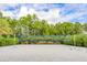 Bright sandy beach volleyball court surrounded by landscaping under blue sky at 816 Longboat Dr, Davenport, FL 33896