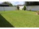 Spacious backyard featuring a white privacy fence, offering a secure and serene outdoor space at 10722 Clover Walk Dr, Orlando, FL 32825
