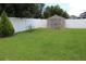 Well-kept backyard with privacy fence and convenient storage shed, ideal for outdoor enjoyment and storage at 10722 Clover Walk Dr, Orlando, FL 32825