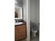 Comfortable bathroom with vanity and an accessible toilet with safety rails and seating at 10722 Clover Walk Dr, Orlando, FL 32825