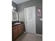 Well-lit bathroom featuring a vanity with a granite countertop and tasteful decor at 10722 Clover Walk Dr, Orlando, FL 32825