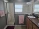 Bathroom features a vanity with sink, glass-enclosed shower, with neutral wall color, creating a refreshing space at 10722 Clover Walk Dr, Orlando, FL 32825
