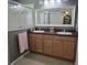Bathroom with double sink vanity, a framed mirror, a glass-enclosed shower, and neutral wall color at 10722 Clover Walk Dr, Orlando, FL 32825