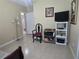 Comfortable bedroom offering natural light, neutral paint, tile floors, and ample space for relaxation at 10722 Clover Walk Dr, Orlando, FL 32825